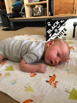 baby lying on a blanket for tummy time